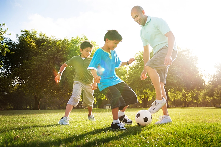 Family playing soccer